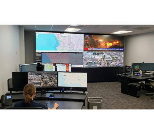 Flying Lion remote pilot monitoring live drone feeds and maps inside a Real-Time Crime Center supporting 24/7 Drone as First Responder operations