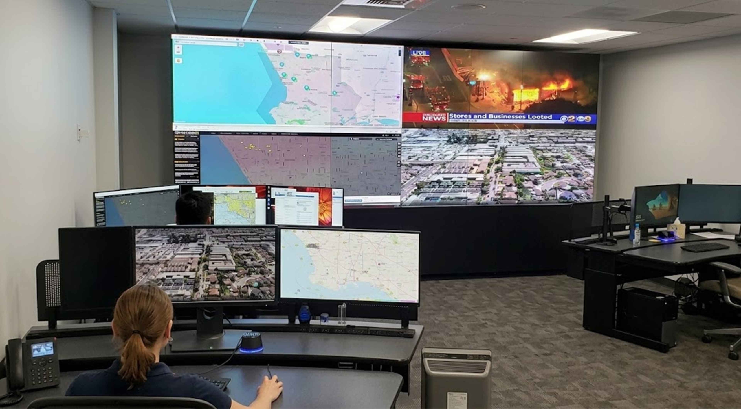 Flying Lion remote pilot monitoring live drone feeds and maps inside a Real-Time Crime Center supporting 24/7 Drone as First Responder operations